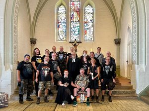 Eine Traugesellschaft steht in einer Kirche. 