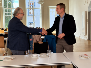Zwei Männer reichen sich die Hand.